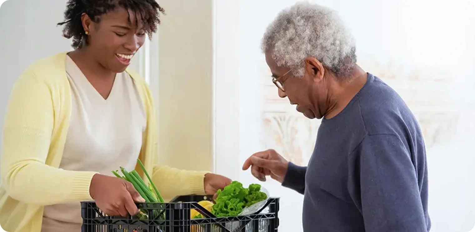 Elderly Man and Carer With Produce [header]