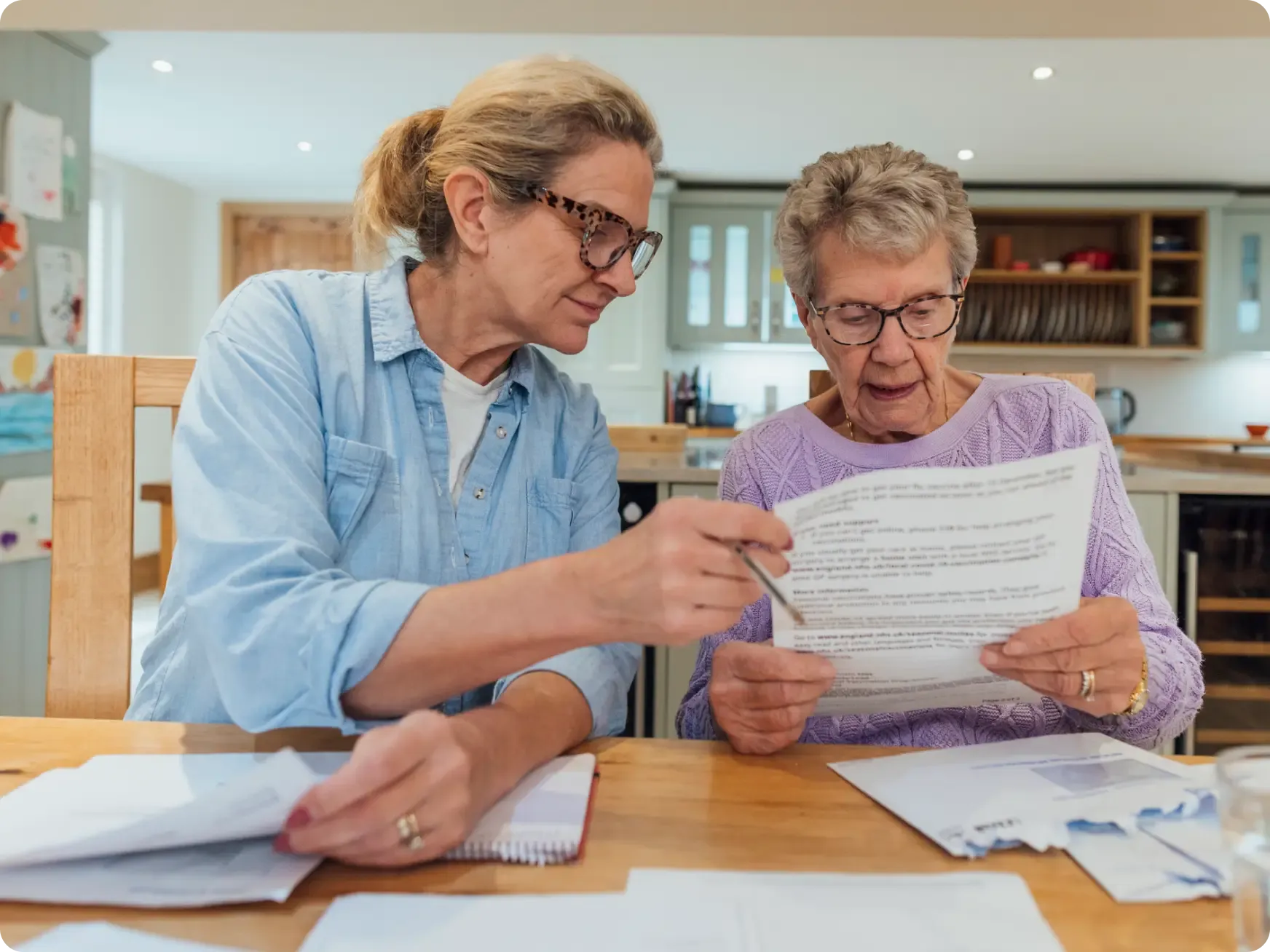 Elderly Women and Carer Doing Paperwork [content]