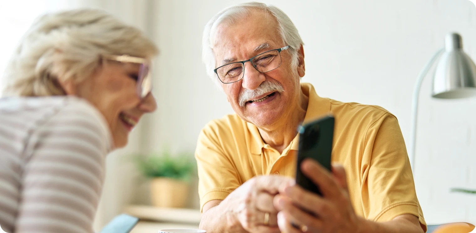 Older Man Point at a Phone [header]