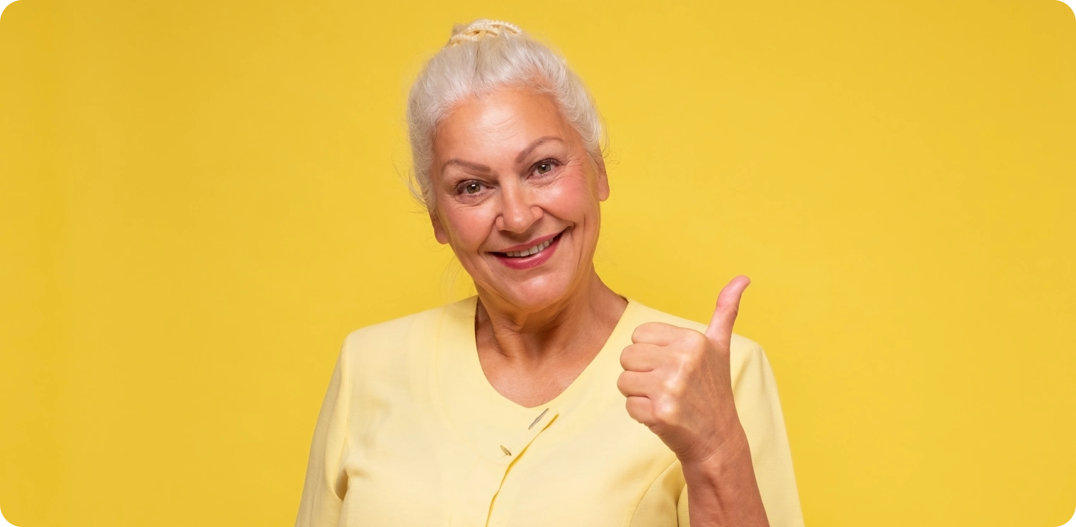Elderly Woman Thumbs up Yellow Background [header]