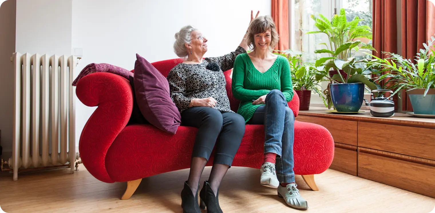 Two Women on Red Couch [header]